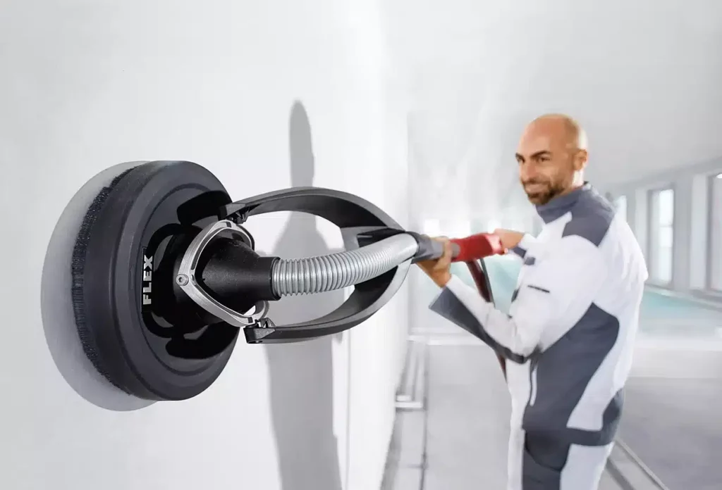 Handyman sanding drywall